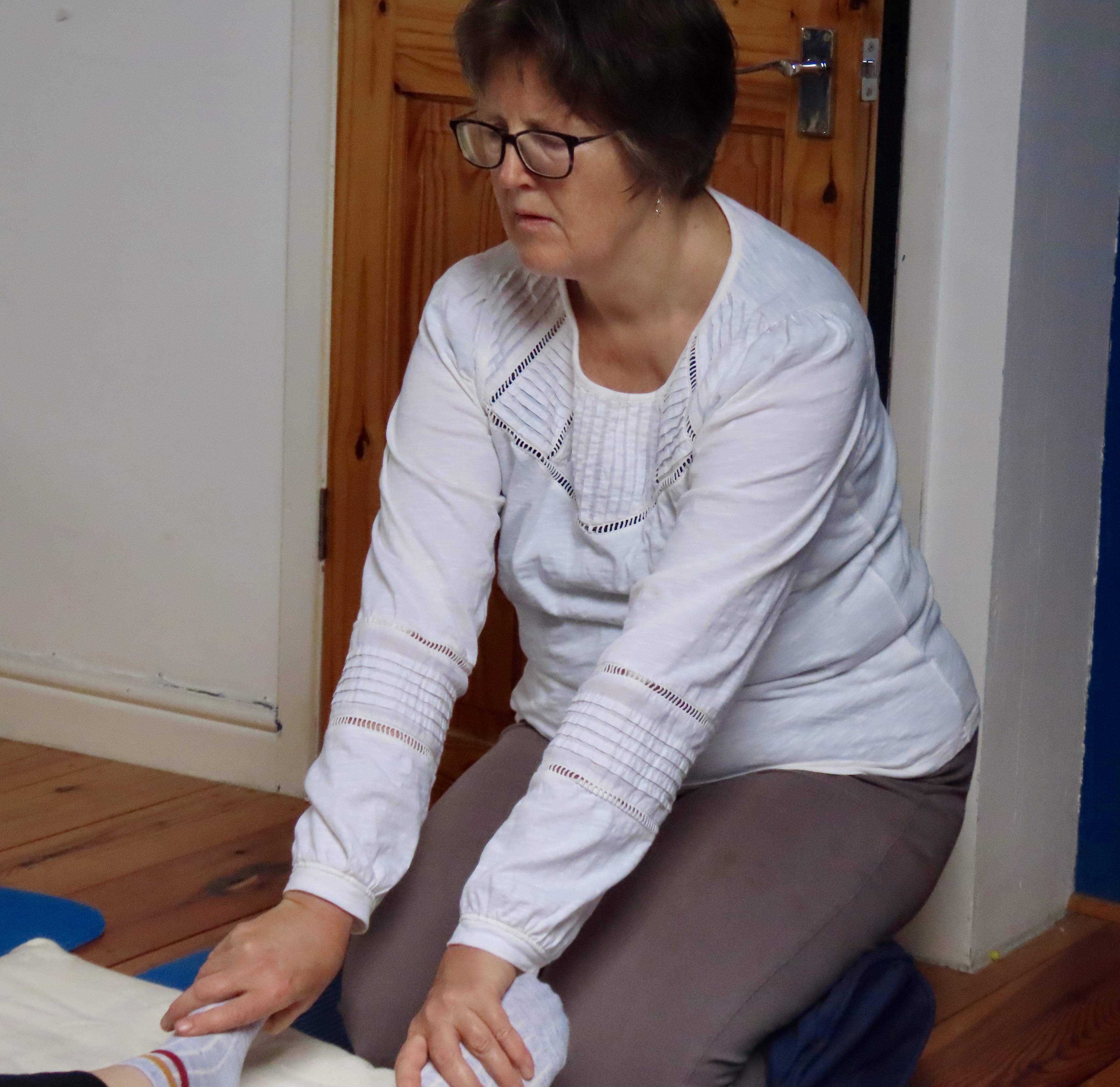 Jo Tomalin doing shiatsu holding a client's feet