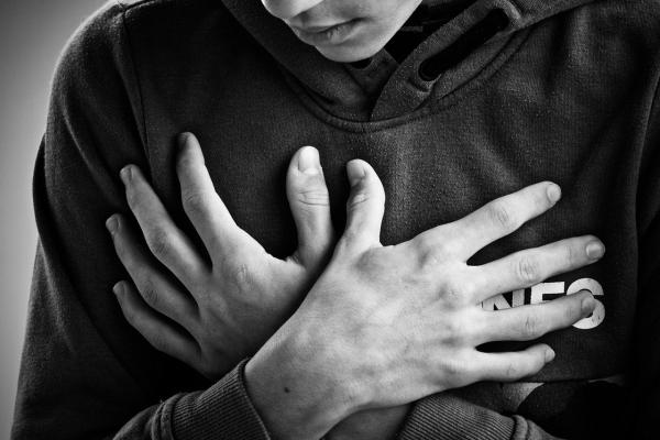 Chronic pain + anxiety person holding heart