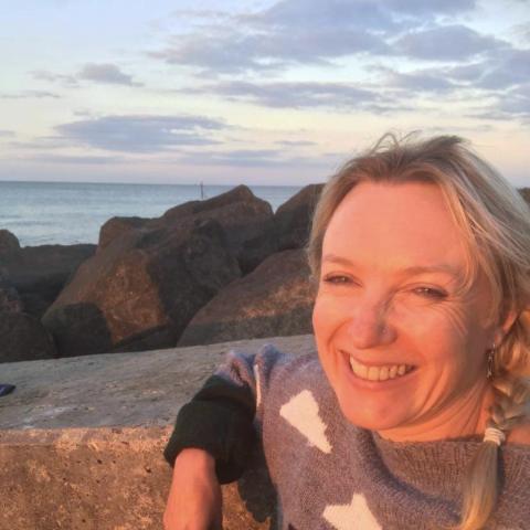 Andrea Brown, white female, pictured smiling on beach in Sheringham