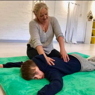 Fiona giving shiatsu to a child